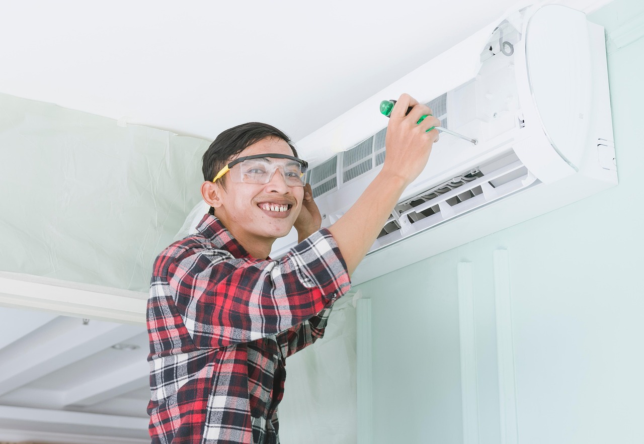 Home services technician working on HVAC system